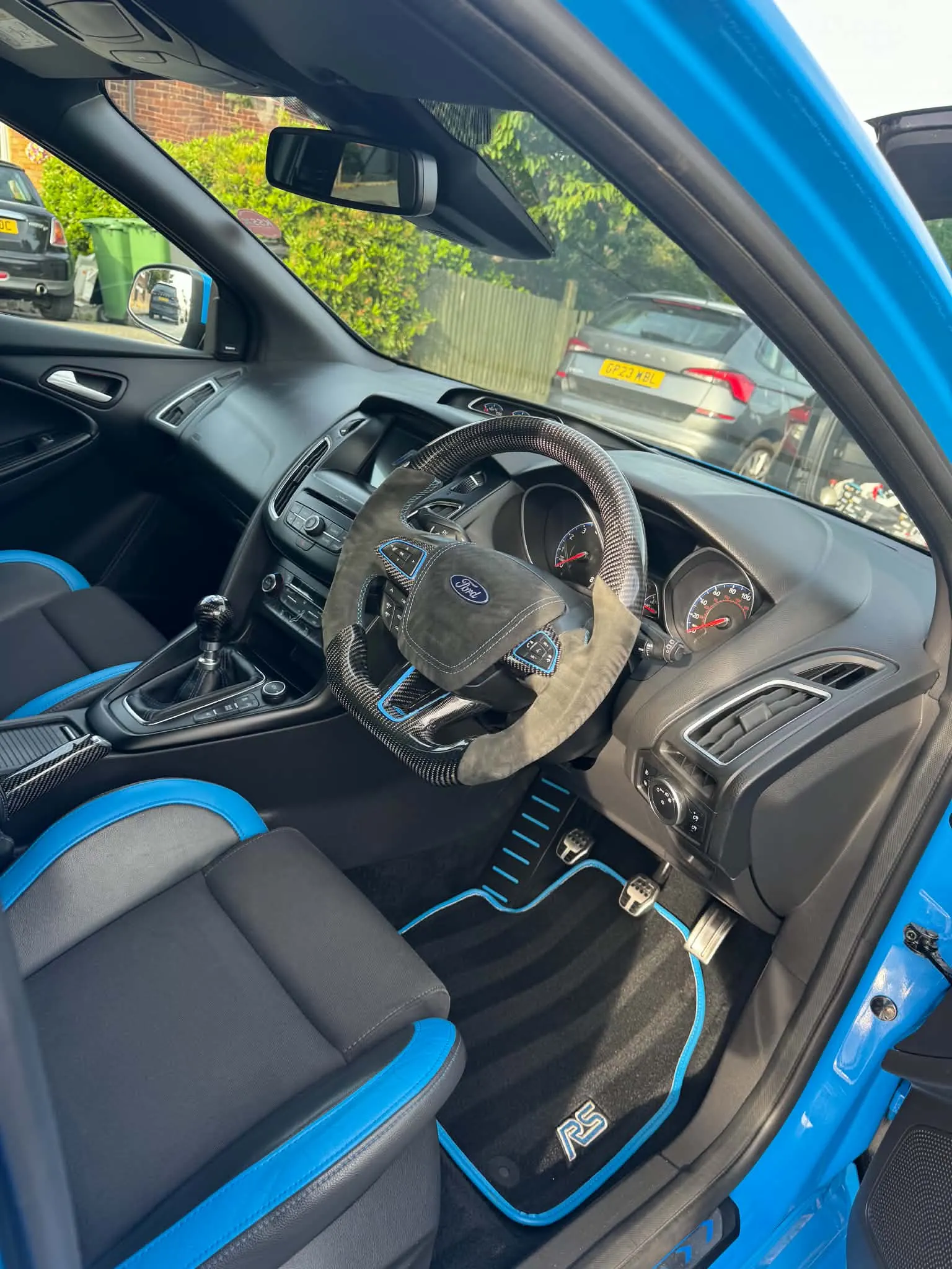 Ford Focus RS dashboard, steering wheel and blue Recaro seats after a premium interior detail