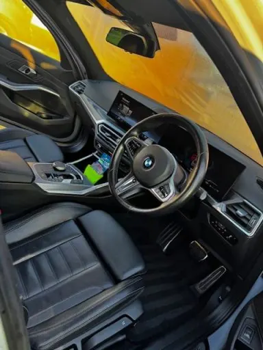 Front seats, gear selector and dashboard of a car after an interior detail